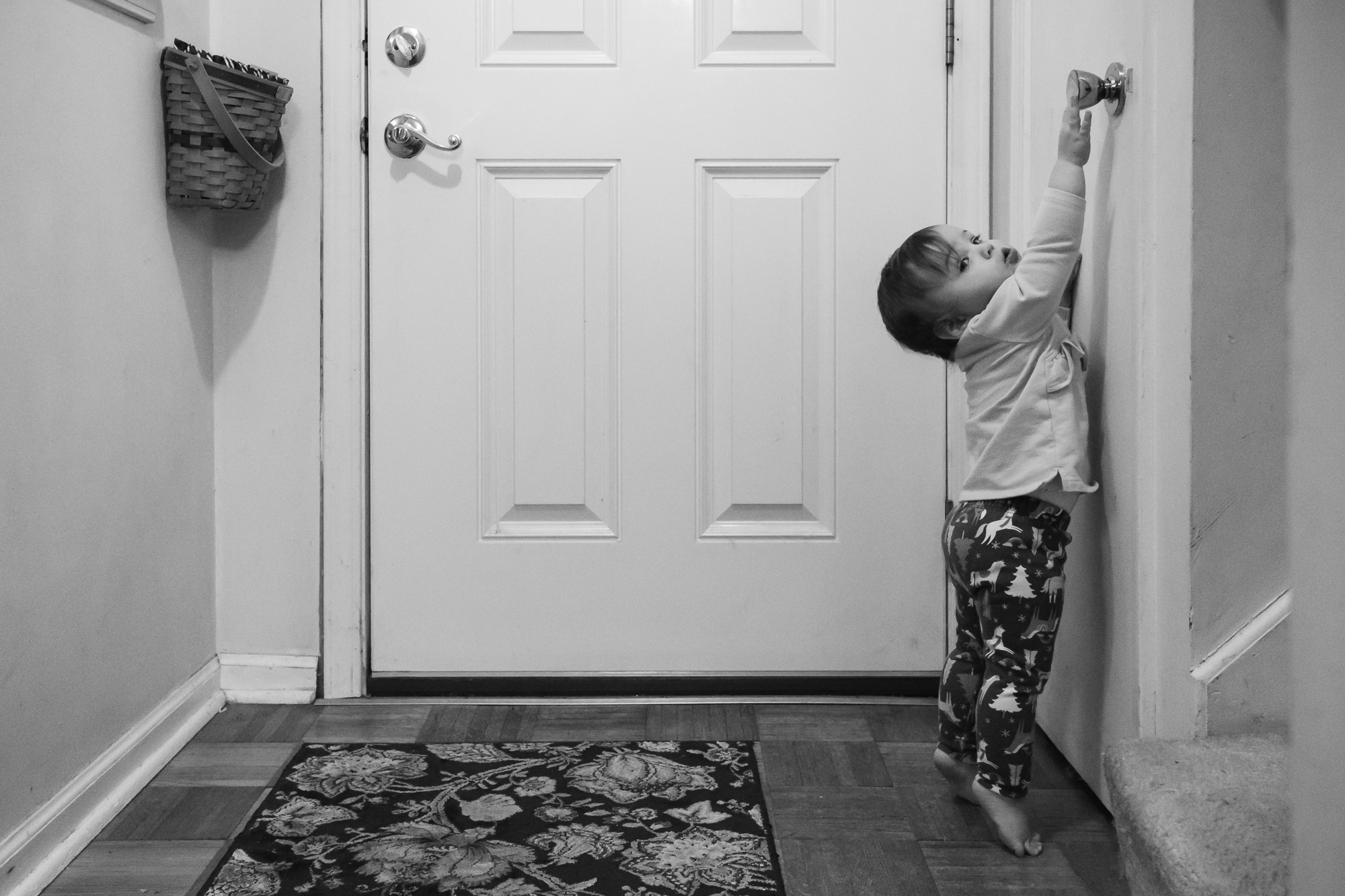 girl reaching for doorknob Documentary Family Photography